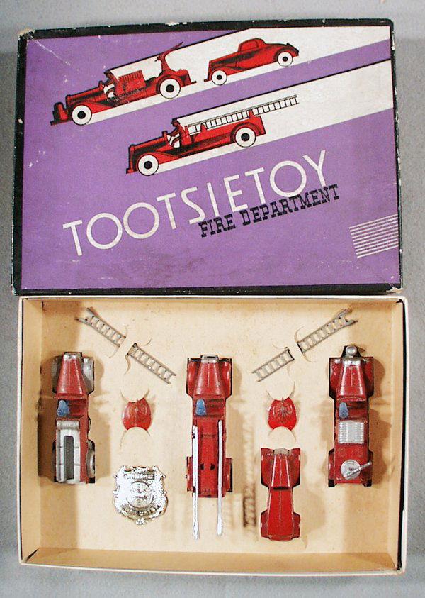 TOOTSIETOY 411 FIRE DEPT SET: contains 1041 Mack Hose Car, 4 tires flat, 1040 Mack Hook & Ladder, 111 Ford Sedan, 1042 Insurance Patrol, Badge, 2 Helmets, orig box & insert minor wear, C5-7. Please read and understand all Terms an
