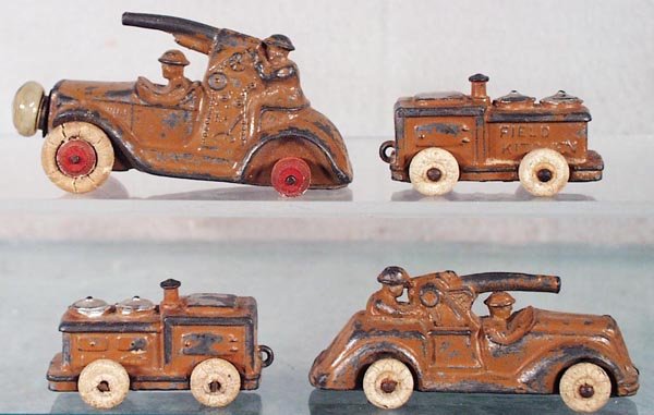 4 BARCLAY ARMY VEHICLES: slush die cast, Cannon Car, w/battery headlight, 3 1/4 in long, missing back tires, cannon bent; 2 Field Kitchens, both have small damage on 1 side; Cannon Car, 3 1/4 in long, 1 tire worn, cannon bent