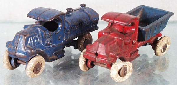 2 CHAMPION MACK TRUCKS: painted cast iron, Gasoline Truck, 5 in long, Dump Truck, 4 1/2 in long, both have worn rubber tires, C4-5.