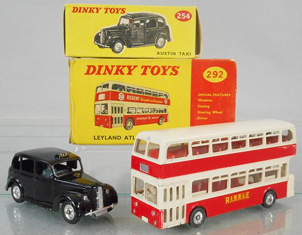2 DINKY VEHICLES: 254 Austin Taxi, black w/Harrods sticker on box, 292 Atlantean Bus, red & cream, w/Ribble decal, orig boxes minor wear, 292 missing an end, C8.