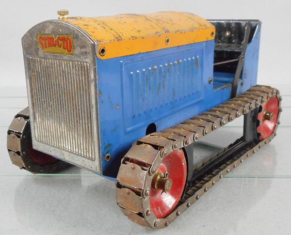 STRUCTO 59 TRACTOR: painted pressed steel, 12 1/2 in long, 7 in wide, 6 1/2 in tall, windup working, w/triple spring motor, blue & orange w/red wheels, metal treads tarnished, minor decal chips on grille, C5-6.