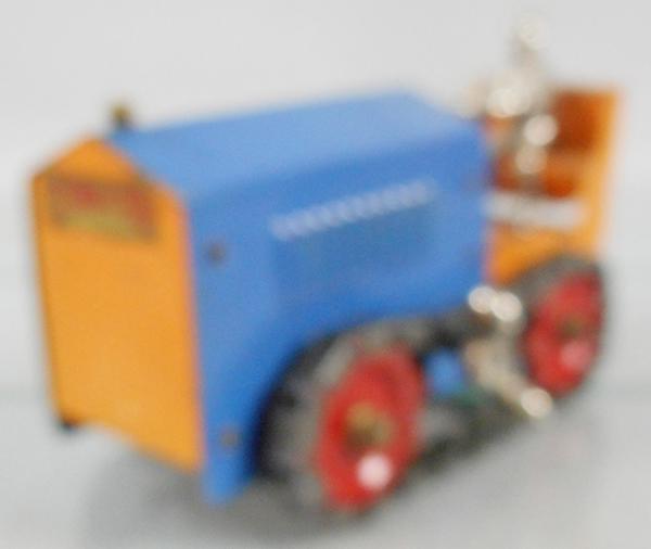 STRUCTO 44 TRACTOR: painted pressed steel, blue & orange w/red wheels, 8 1/2 in long, windup, nickelplated cast iron driver, C6-7.