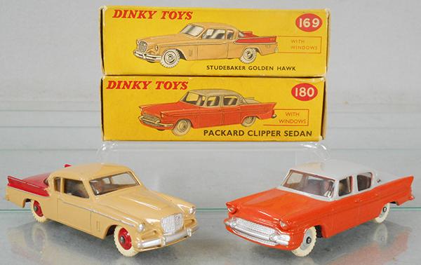 2 DINKY AUTOS: 169 Studebaker Golden Hawk, tan & red w/red hubs, 180 Packard Clipper, orange & gray w/gray hubs, orig boxes minor wear, w/correct color dot, C8-9.