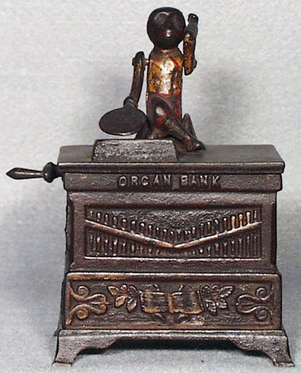 KYSER & REX ORGAN BANK: painted cast iron, medium sized, working, w/broken cap, Fair.