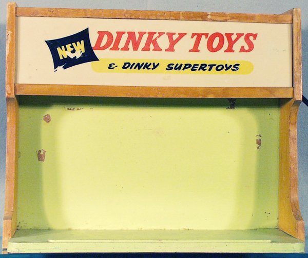 DINKY TOYS STORE DISPLAY CASE: wood & painted wood, plastic sign, plastic warped, lettering worn, 16 1/2 in by 6 1/4 in by 13 1/2 in, wear to paint & wood from use, electric, working, C5.