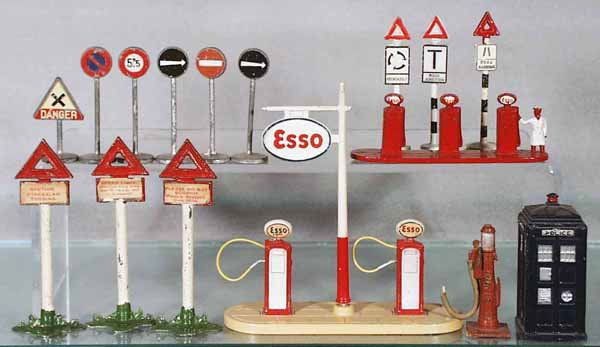 DINKY ACCESSORIES: 6 Signs from set 771; 3 Signs from set 47; 781 Esso Gas Pumps; 1 Pump from set 49C; 42A Police Box; w/Lesney Gas Island & 3 Timpo Signs, C4-6.
