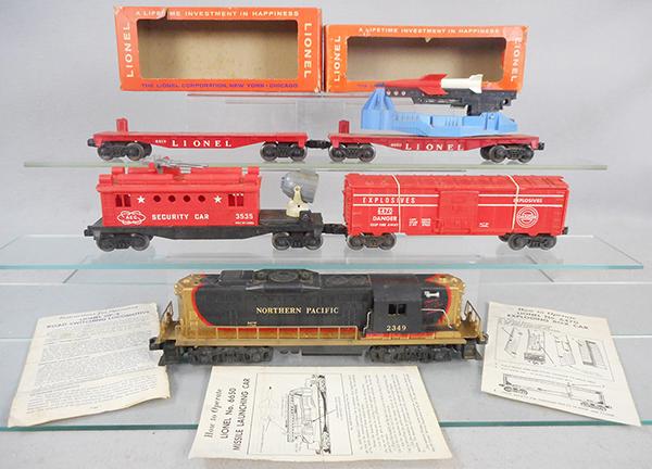 LIONEL TRAIN SET: O ga, 2349 Northern Pacific GP9, 6470 exploding box car, missing pin, 3535 security car, 6650 missile launching car, 6819 helicopter car, missing helicopter, w/instruction sheets, 2 orig boxes only, p