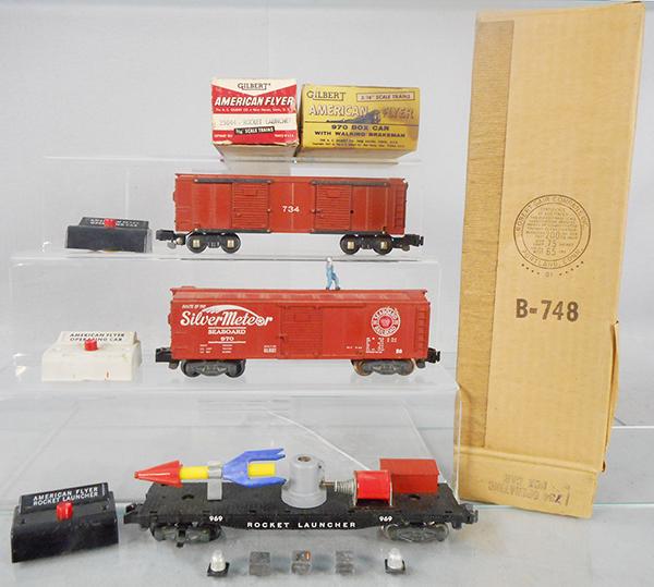 3 AMERICAN FLYER OPERATING CARS: S ga, 734 box car w/conversion couplers, 970 walking brakeman car, 969 rocket launcher flat car, w/buttons & cargo, orig boxes minor wear, 1 missing end flap, C6-7.