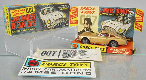 CORGI 261 JAMES BOND ASTON MARTIN: gold, all functions working, w/packet, orig box & insert minor wear, all flaps intact, C7-8.