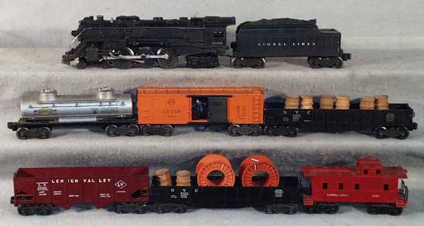 LIONEL TRAIN SET: O ga, 2056 loco, 1 jewel housing broken off, 2466WX tender, missing 1 roller pickup, 6465 tank, 3464 SF box car, 1 broken coupler, 6462 gondola w/barrels, 6456 hopper, 6462 gondola w/cable reels, 6057