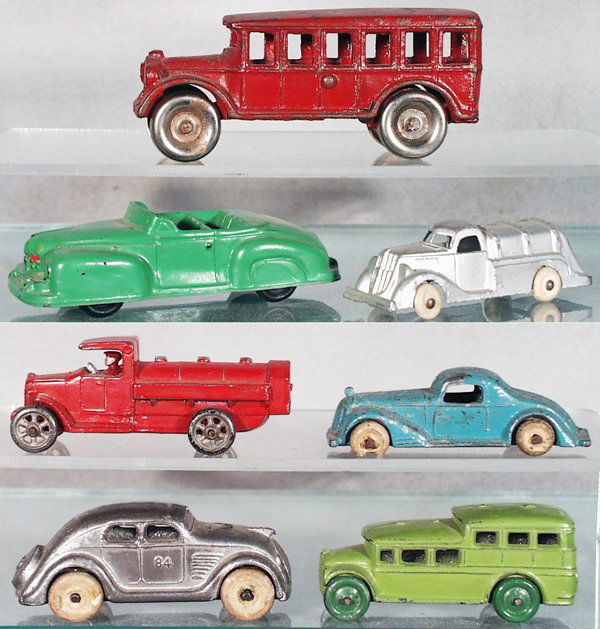 7 TOY AUTOS: Arcade Bus, painted cast iron, 4 3/4 in long; Auburn Rubber Lincoln, 4 1/2 in long; HubleyTanker, 3 1/2 in long; CAW Tanker, slush, 3 3/4 in long; Lincoln Pontiac, slush, 3 1/4 in long; Kansas Toy Air