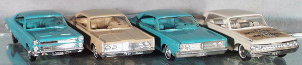 4 AMT PROMOS: plastic, 1966 Comet w/1961, 1965 & 1966 Mercurys, 1961 has advertising stickers, stickers are worn & discolored, 2 have oxidation on axles, 1 is friction working poorly, C5-8.