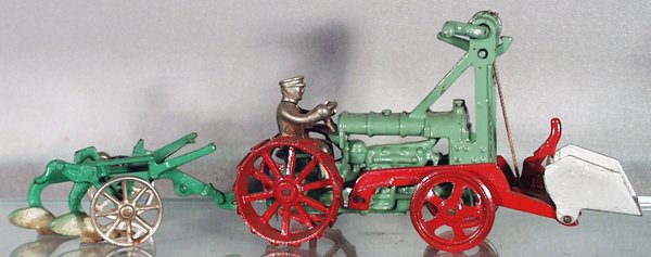 2 CAST IRON FARM VEHICLES: painted cast iron, Hubley Fordson Tractor, 9 1/4 in long, nickel driver; Arcade Oliver Plow, nickel wheels, 5 1/2 in long, some oxidation on whels, axle & blade, C4-6.