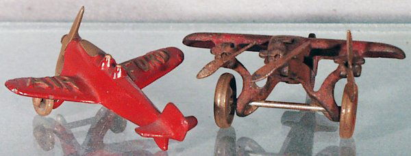 2 CAST IRON AIRPLANES: painted cast iron, Hubley Air Ford, nickel wheels & propellers, 3 3/4 in wingspan, light oxidation on wheels & props, C6; Arcade Trimotor, nickel wheels & propellers have heavy oxidation, playworn, 4