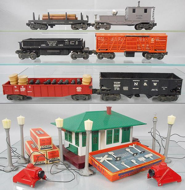 LIONEL LOT: O ga, 6 #71 lamp posts, missing 1 lamp top, 3 orig boxes, 132 station, 309 yard set, orig box & insert, 2 #260 bumpers, 3461 lumber car, 6420 searchlight caboose, 3469 dump, 3656 cattle car, 6462 gond