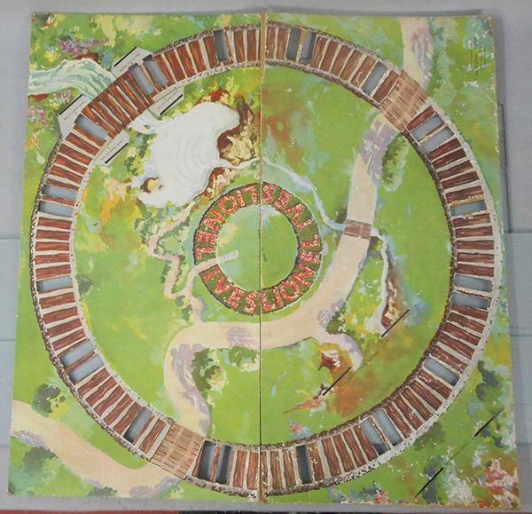 LIONEL IVES MECHANICAL TRAIN LAYOUT: O ga, cardboard, w/colorful printed litho layout, 28 1/2 by 28 1/2, 2 pieces, dated 1933, some wear from use, C6-7.