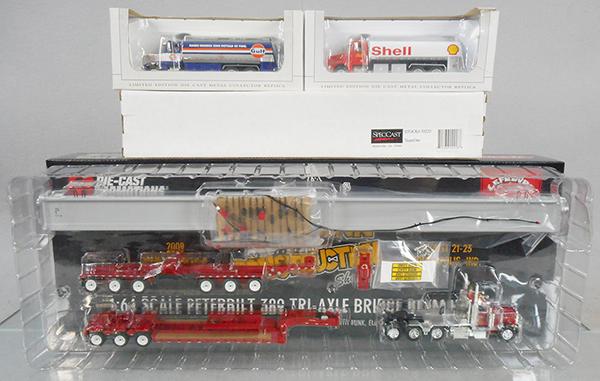 4 SPEC CAST & DIE CAST PROMOTIONS VEHICLES: Spec Cast 33051 Gulf Tank, 33015 Shell Tank, 30223 Team One Truck, Die Cast Promotions 32165 Peterbilt 389 Tri Axle Bridge Beam Hauler, orig boxes minor wear, C8-9.