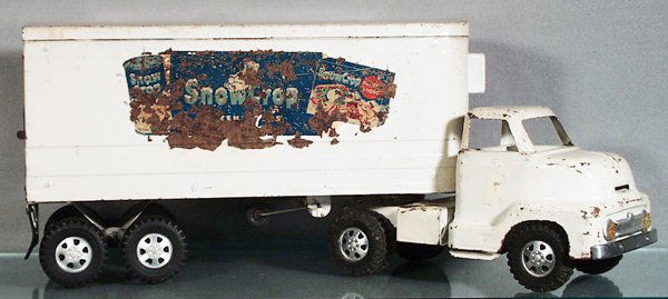 DUNWELL SNOW CROP TRACTOR TRAILER: painted pressed steel 23 in long, white touch up spots over all, decals worn & have rust spots, C2-3.