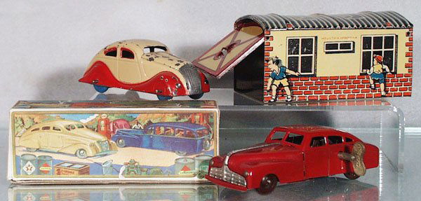 RICO TIN CARS & GARAGE: painted & lithographed tin, Chrysler Airflow, red & tan, paint flaking, 5 in long, windup working; 229 Hudson, red, 5 1/4 in long, windup not working, orig box; Garage, made in Argentina, 5 in long, C