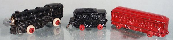BARCLAY ELECTRIC TRAIN SET: slush die cast, 3 pieces, loco has electric headlight, small chip on side of loco, w/tender & coach, both missing tires, 9 in long, C6-7.