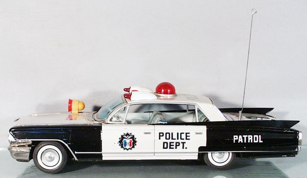YONEZAWA CADILLAC POLICE CAR: Japan, lithographed & handpainted tin, plastic, black & white w/black rubber tires, friction working, 21 1/2 in long, minor scratches & playwear, C6.