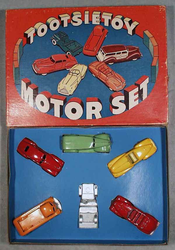 TOOTSIETOY 7200 MOTOR SET: 1946, contains red Buick Special, green Ford Wagon, front bumper broken, yellow Buick Y, red Chrysler Windsor, silver Jeep, orange Hudson Pick Up, all have postwar black tires, orig box & insert minor