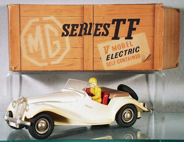 VICTORY MODELS MGTF: plastic, white MGTF, battery operated, not tested, 8 1/2 in long, front license plate decal chipped, w/added loose driver, orig box & simulated cardboard crate cover missing 1 end flap, C7.