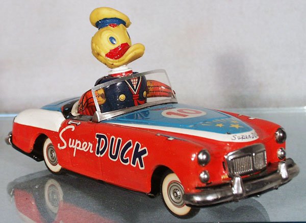 ICHIKO SUPER DUCK MG: litho tin, friction working, rubber duck head, arms move slowly, windshield frame broken & replaced, 8 1/4 in long, C6.
