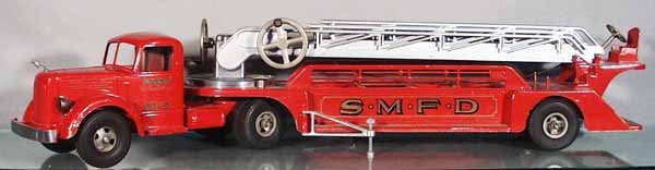 SMITH MILLER 410 AERIAL LADDER TRUCK: die cast, ladder elevator not working, missing 1 stabilizer foot, repro hood ornament, bumper tip broken but there, 36 in long, C7.