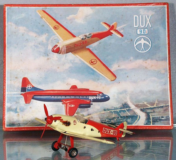DUX-90 AIRPLANE: litho tin, windup not working, w/plastic propeller & cockpit cover, 8 1/2 in wingspan, scorch mark on 1 side by decal & propeller, w/key & tool, orig box & insert, C5-6.