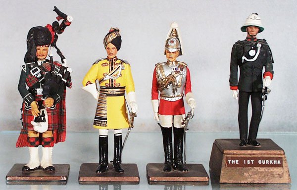 4 SENTRY BOX FIGURES: Black Watch Piper, Skinner's Horse Officer, Officer of the Life Guards, 2 paint chips on face, 1st Gurkha Officer, 5 to 6 in tall, C6-8.