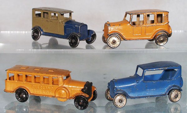 4 TOOTSIETOY VEHICLES: no-name Sedan, blue & tan, missing rear fender tips; 4629 Yellow Cab; 4680 Overland Bus, orange, rear awning chipped; 4641 Touring Auto, blue, C3-4.
