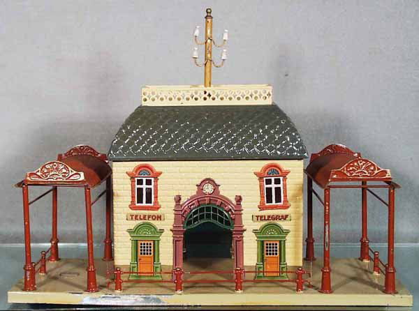 BING CENTRAL STATION: litho & handpainted tin, later version w/logo badge, base has some paint flaking on edge, 15 in long by 6 in deep by 11 in tall, C7-8.