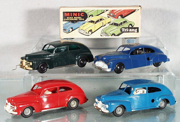 4 MINIC AUTOS: plastic, 3132 Buick, blue, clockwork working, orig box; 3 #3131 Ford Tudor, the blue is clockwork working, the red is friction working, the green is rubberband powered & working, w/Triang Minic Push a