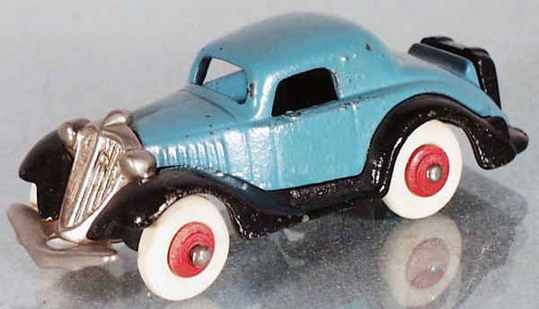 HUBLEY COUPE: painted cast iron, 4 1/4 in long, blue & black, minor paint chipping, white rubber tires have some flat spots, C7.