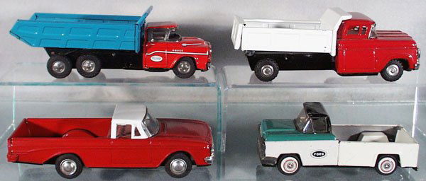4 TOY TRUCKS: Japan, litho tin, friction working, black rubber tires, Mitsuhashi 1958 Dodge Dump Truck, 8 1/2 in long, some scratches; Ford Dump Truck, 8 in long, some scratches; Chevy Pick Up Truck, 8 in long; Lin