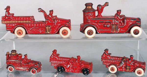 5 BARCLAY FIRE TRUCKS: slush die cast, Ladder Wagon, 4 1/2 in long; Pumper, 4 in long; both are missing their bells, Pumper, 2 1/4 in long, 2 Ladder Trucks, 2 3/4 in long, C4-5.