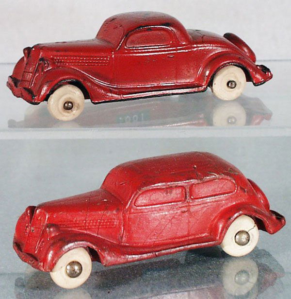 2 1935 FORD AUTOS: painted rubber, 4 in long, Auburn Rubber Ford Coupe, red w/white rubber tires, the number 6 has been written in marker on the roof; Seiberling Ford 2-Door Sedan, red w/white rubber tires, 1 tire split