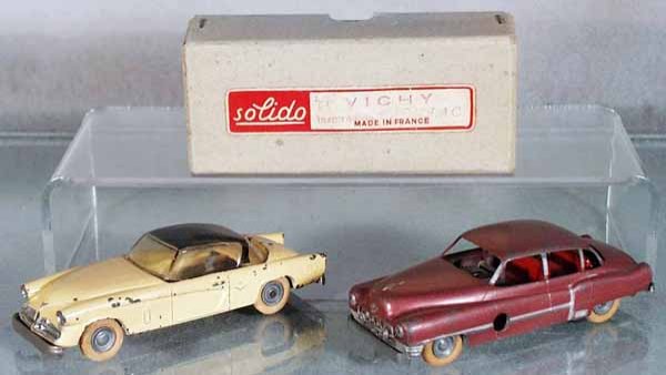 2 SOLIDO VEHICLES: 115 Studebaker, yellow, windup working, tires have flat spots, paint chipped, 90 Cadillac, rose, windup working, orig box, C5-7.