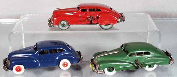 3 TIN VEHICLES: Occupied Japan, painted tin, 1947 Buick Sedan, green, windup working, 5 1/4 in long; 1947 Buick Sedan, red, some paint chipping, 5 1/4 in long; Chevrolet Sedan, some paint chipping, windup not working