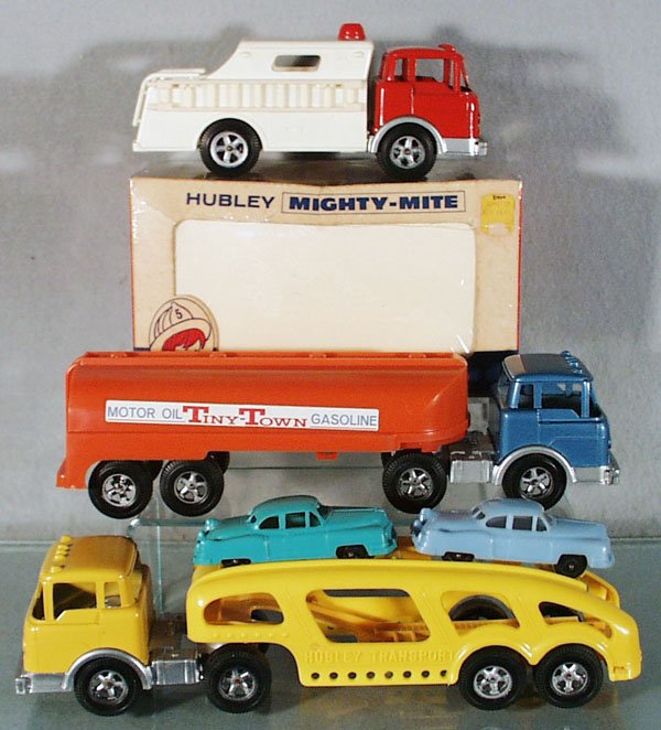 3 HUBLEY MIGHTY MITE TRUCKS: plastic & die cast, 1493 Rescue Fire Truck, 8 in long, orig box minor wear, 1514 Tiny Town Gas Tanker, 12 in long, 1511 Auto Transport w/ramp & 2 Cadillacs, 12 1/2 in long, C8-9.