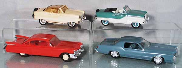 4 PLASTIC PROMO CARS: 2 Hubley Nash Metropolitans, 1 missing its hardtop roof, both 6 1/2" long; Johan 1959 Cadillac, 8 1/2" long, windshield foggy, Johan 1968 Cadillac Eldorado, 8 3/4" long, windshield foggy, all are fric