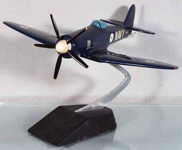 US NAVY FIGHTER PLANE: handpainted hardwood, made from Cleveland Model plans from the 40's to 60's, 14 1/2" wingspan, w/Kangaroo insignia & tailhook, mounted on pylon, good detail, expertly done, C9.