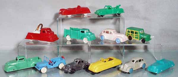 12 PLASTIC VEHICLES: rom 3 1/2" to 5 1/4" long, manufacturers include Archer, Superior, Lapin, Hercules & Wannatoy, the wrecker is missing its tow hook, the police car is missing its convertible roof, the stake truck has 