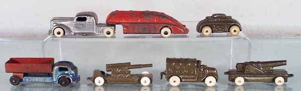 6 RALSTOY VEHICLES: slush die cast, Gasoline Tanker, 6 1/2" long, small damage on bottom, Tank, 2" long, Dump Truck, 3 1/4" long, Cannon Trailer, 3" long, Army Truck, 2" long, Cannon Trailer, 3 1/4" long, missing 1 latch