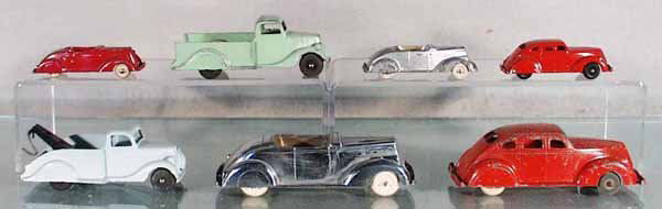7 ERIE AUTOS: red Packard, 3 1/2" long, green Ford Pick Up, 5" long, silver Packard, 3 1/2" long, red Zephyr, 3 1/2" long, blue Ford Wrecker, 5" long, chrome Packard, 6" long, red Zephyr, 5 3/4" long, C4-7.
