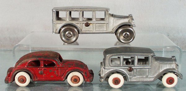 3 DENT VEHICLES: Bus, aluminum, 5" long, Sedan, aluminum, 4 1/2" long, Chrysler Airflow, painted cast iron, 5" long, heavy paint wear, C4-6.