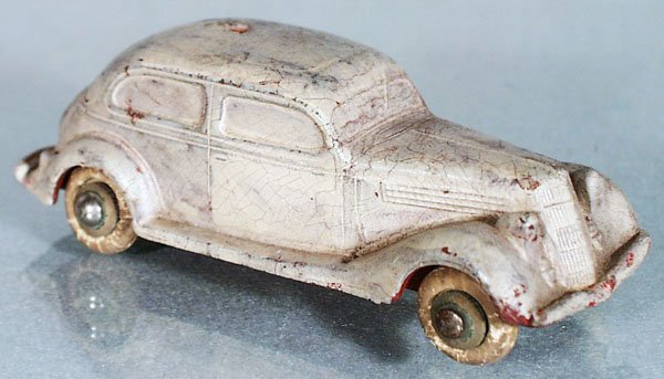 SEIBERLING 1935 FORD: 5" long, white rubber tires rough, repainted sloppily in white, hole in roof, small end of front fender broken off, C2.