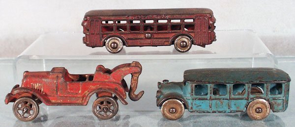 3 CAST IRON VEHICLES: painted cast iron, AC Williams Twin Coach, 5" long, Hubley Wrecker, 4 1/2" long, AC Williams Bus, 4 1/2" long, C3-4.