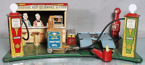 MARX ROADSIDE REST SERVICE STATION: painted pressed steel, 13 1/2" by 10", w/litho tin accessories, complete w/motor oil dispenser & water can, rubber hoses parts, both gas light bulbs are plastic, C6-7.